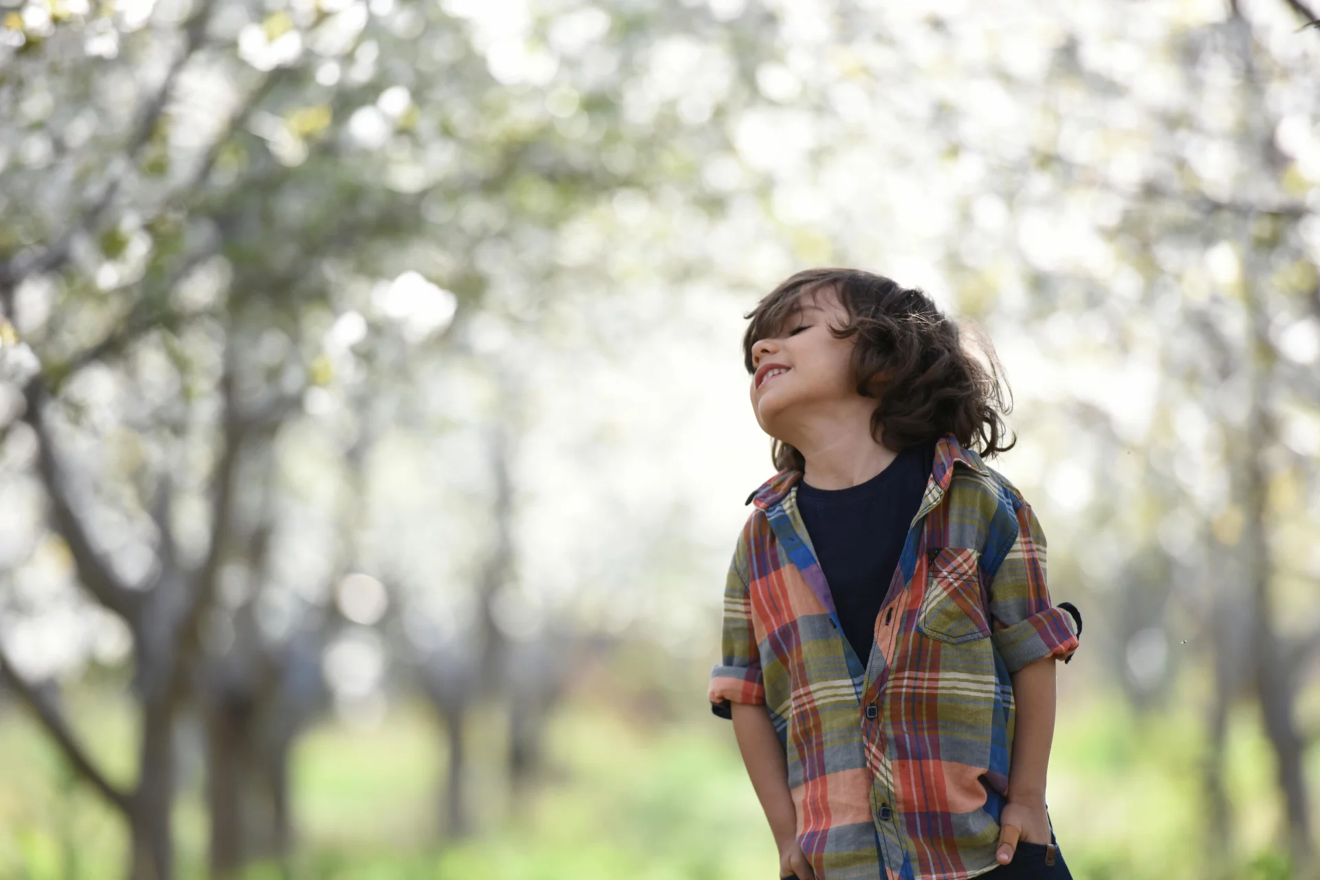 A happy child breathing deeply in nature