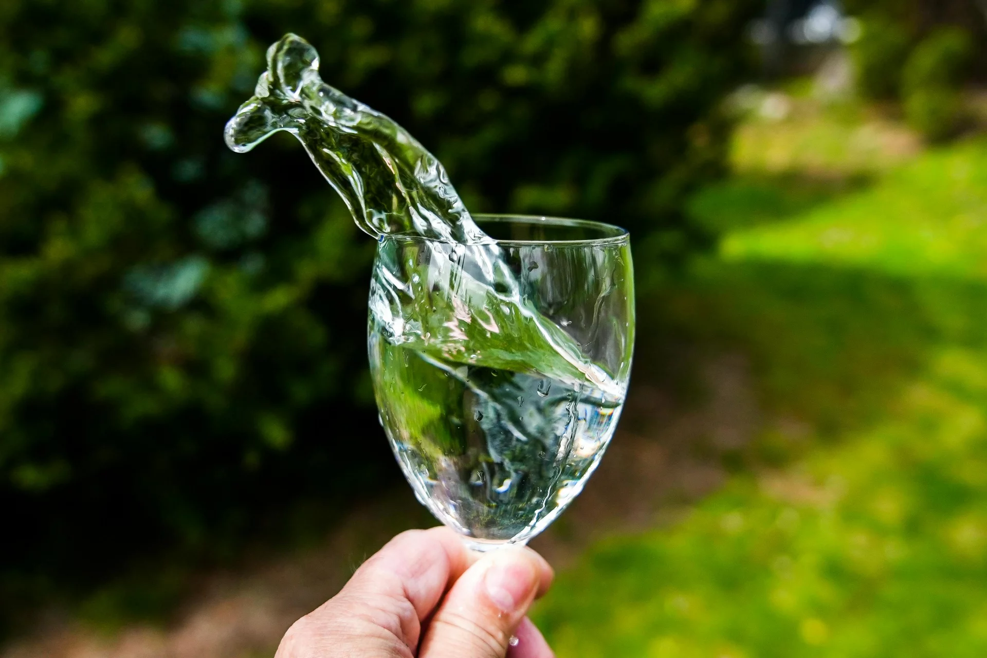 Crystal clear water with splashes on a light background